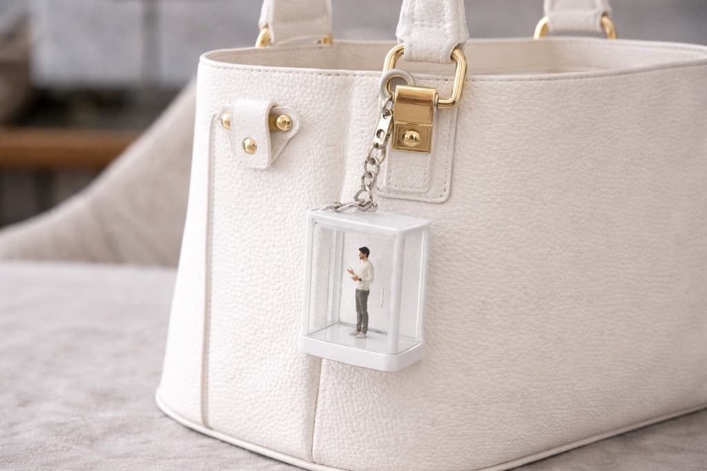YAP Box keychain attached to a white tote bag